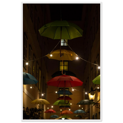 Nighttime street scene with colorful illuminated umbrellas hanging as decoration above a vibrant outdoor area on a wooden frame wall art