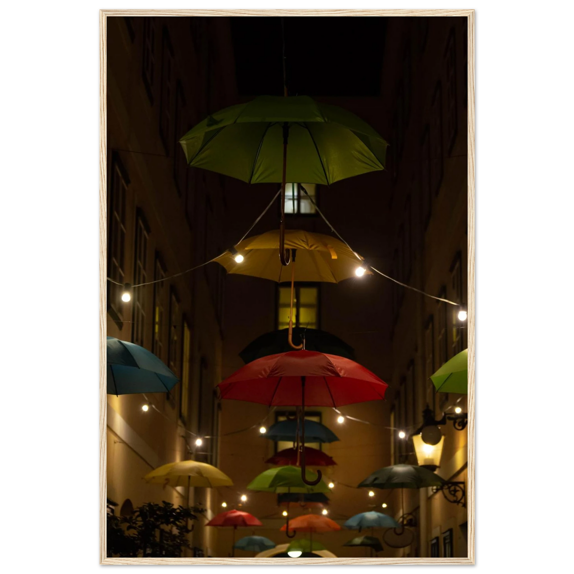 Nighttime street scene with colorful illuminated umbrellas hanging as decoration above a vibrant outdoor area on a wooden frame wall art