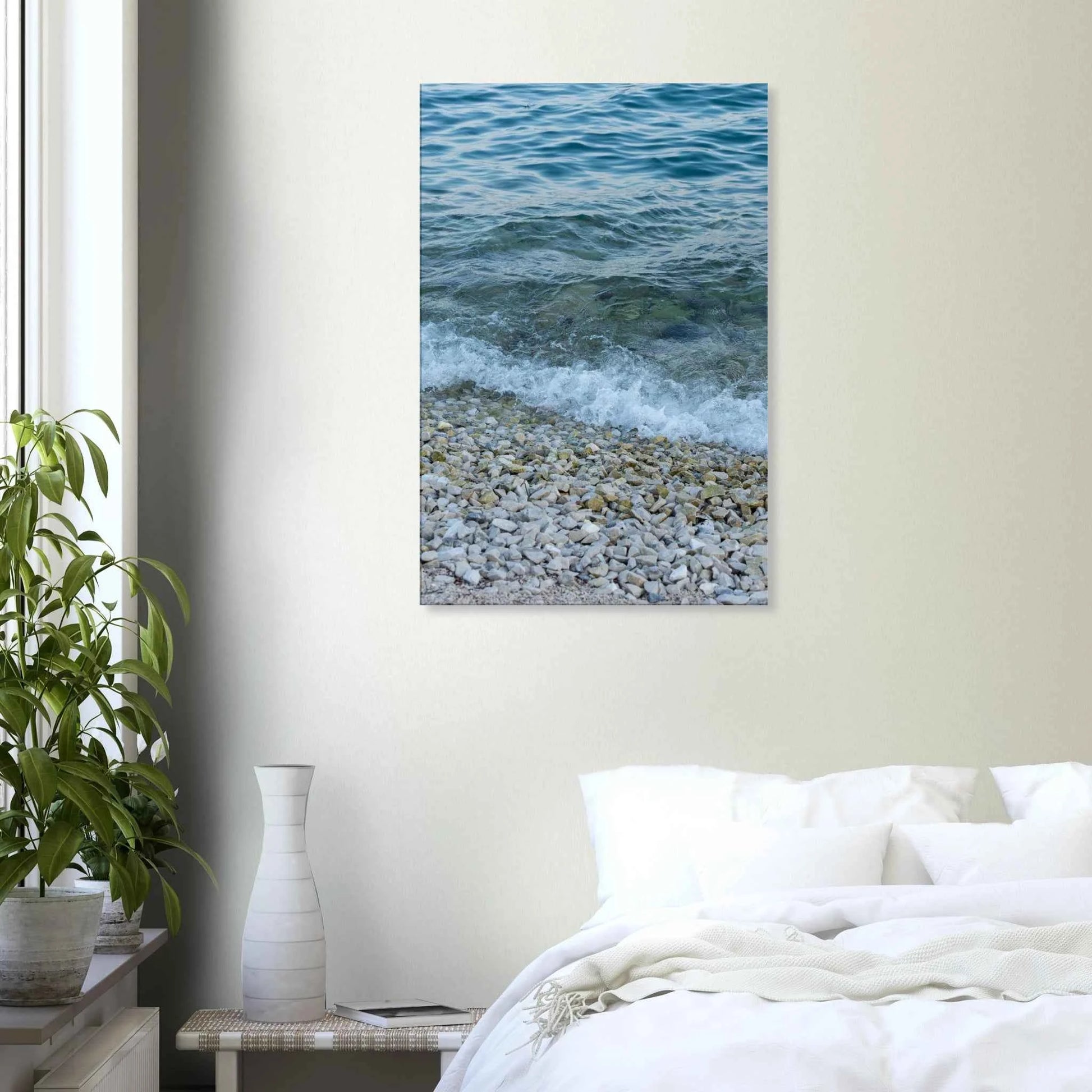 Aerial view ocean beach with wood frame canvas print, top down drone shot of blue sea foam and pebbles on the wall in the Bedroom
