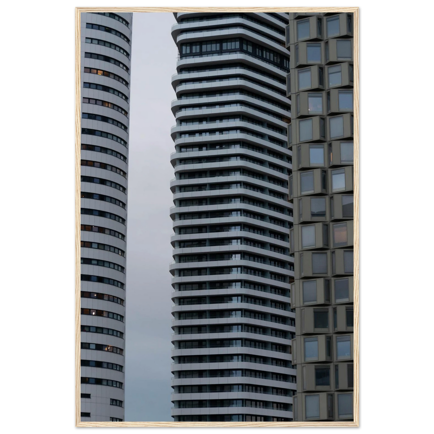 Modern high rise tower buildings with glass and steel facade reaching into the sky on wodden framed wall art