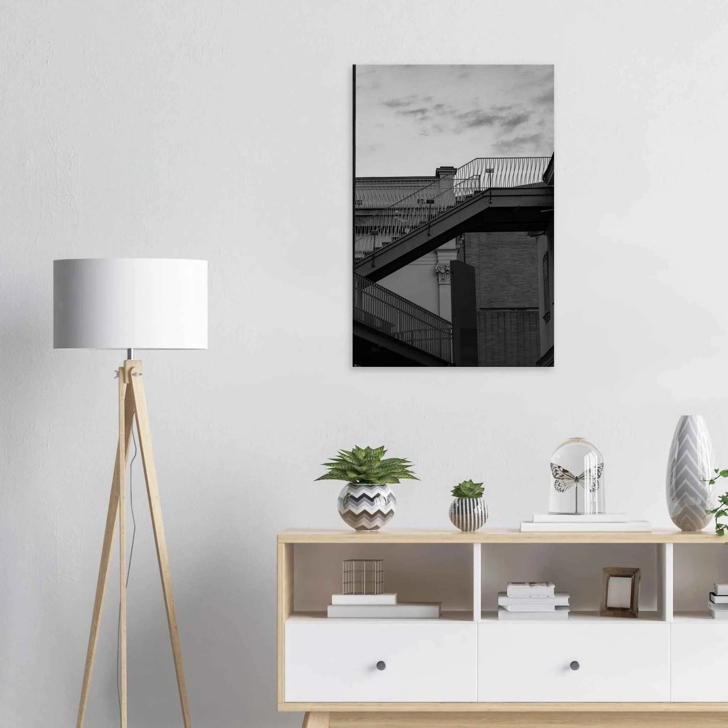 Black and white photo on a Canvas Print wall art of an outdoor staircase connecting two buildings under a dramatic cloudy sky on the wall in the Livingroom