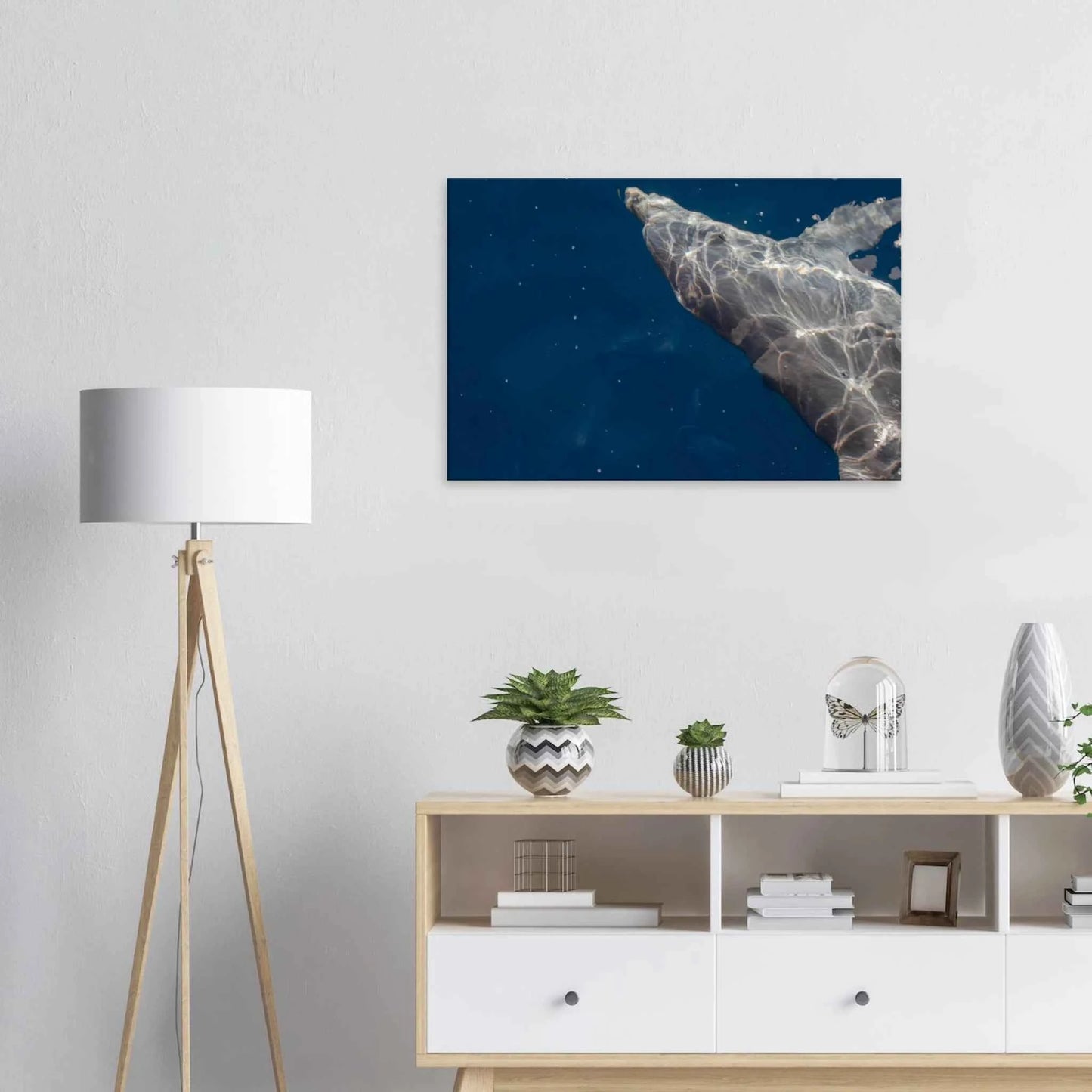 Canvas print wall art featuring a close-up of a Dolphin swimming under the surface of crystal clear blue sea water on the wall in the Livingroom