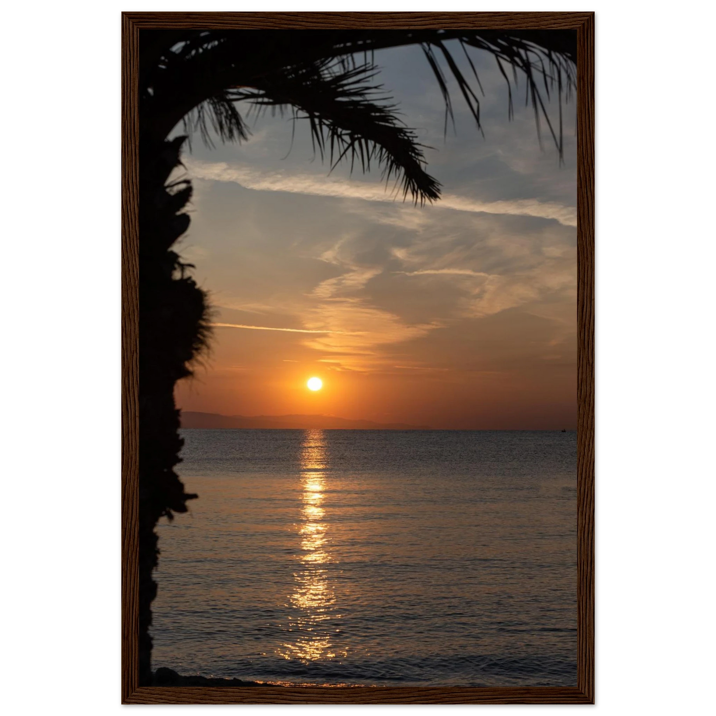 Wooden framed wall art Sunset over calm water with golden reflections, framed by tree branches in a peaceful natural landscape
