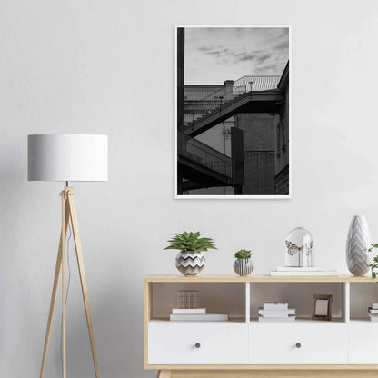 Black and white photo on a wooden frame wall art of an outdoor staircase connecting two buildings under a dramatic cloudy sky on the wall in the Livingroom