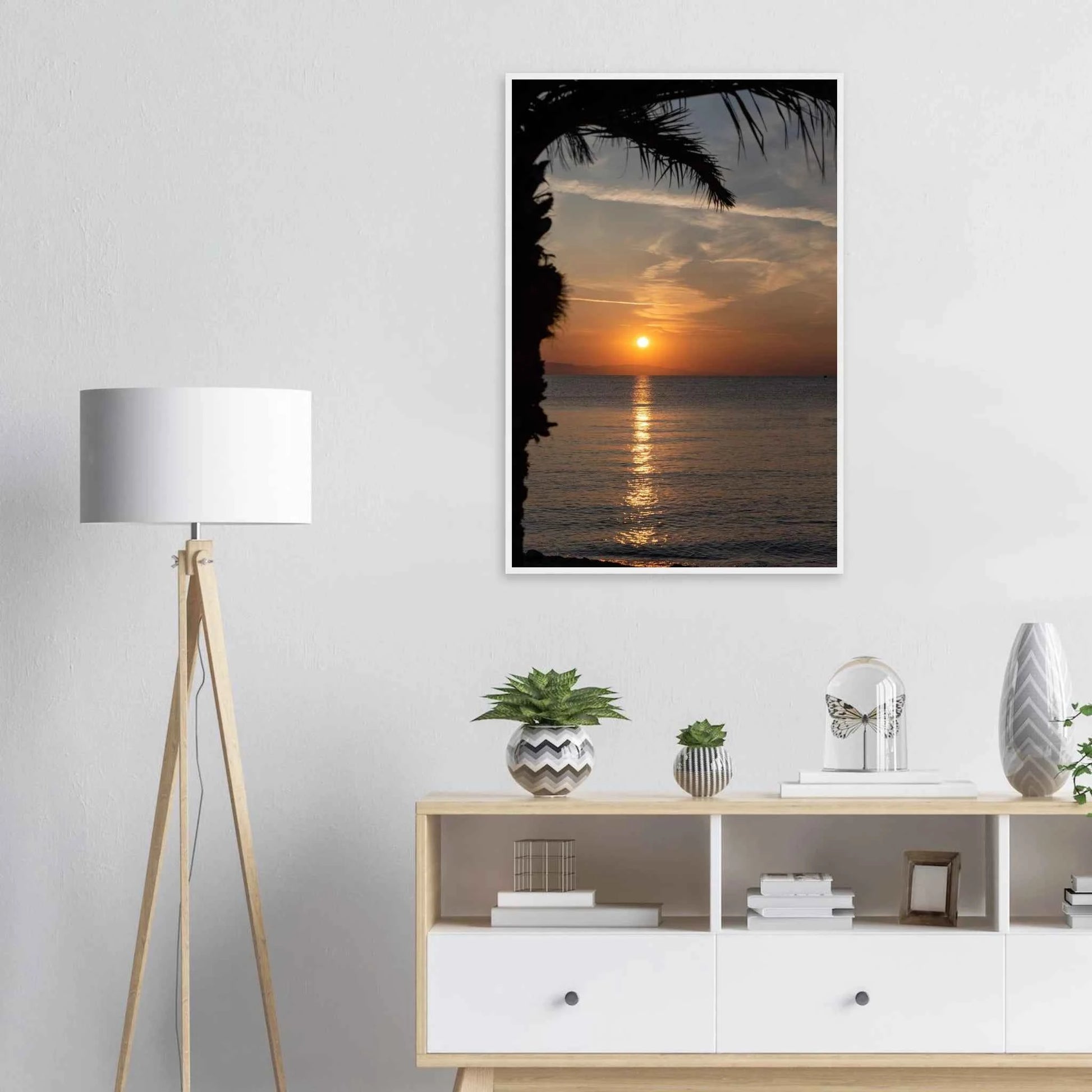 Wooden framed wall art Sunset over calm water with golden reflections, framed by tree branches in a peaceful natural landscape on the wall in the Bedroom