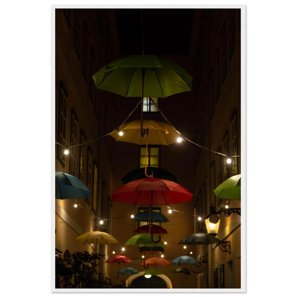 Nighttime street scene with colorful illuminated umbrellas hanging as decoration above a vibrant outdoor area on a wooden frame wall art
