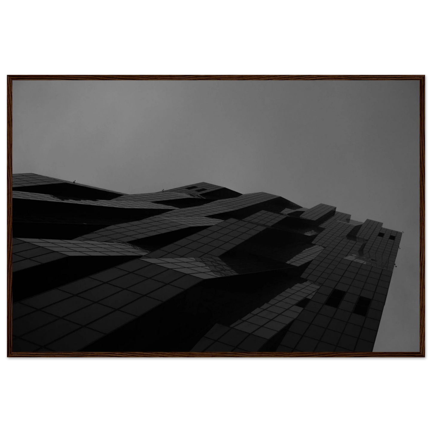 Black and white low angle view of a modern skyscraper with bold geometric lines and dark textured facade on wooden framed wall art