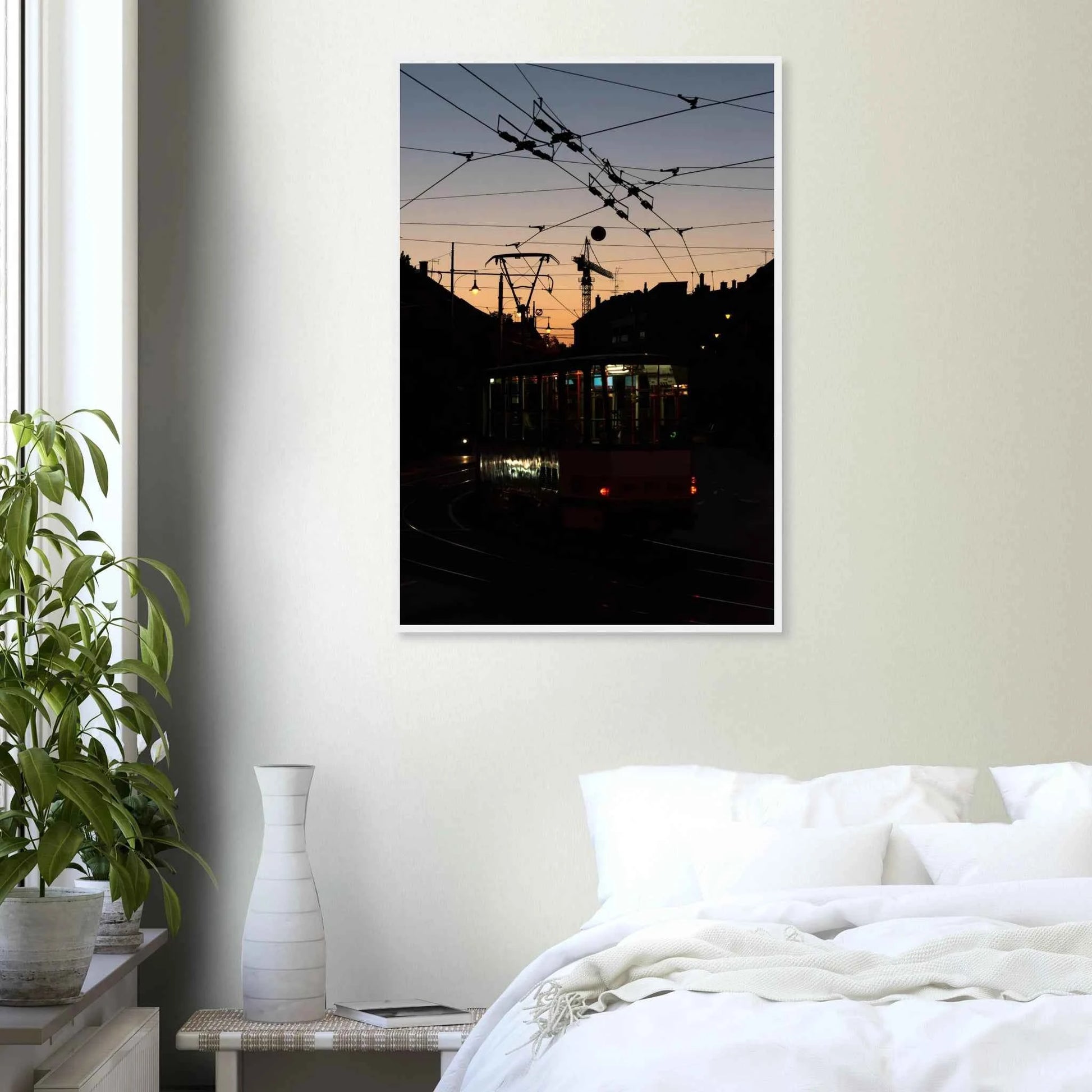 Wooden framed wall art featuring a tram the Nightline driving between houses under power lines during a golden sunset on the wall in the Bedroom