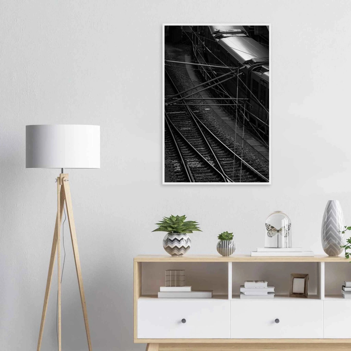 Black and white aerial view of metro train and railway tracks in an urban underground or elevated rail system on wooden framed wall art on the wall in the Livingroom