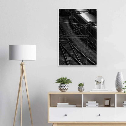 Black and white aerial view of metro train and railway tracks in an urban underground or elevated rail system on wooden framed wall art on the wall in the Livingroom