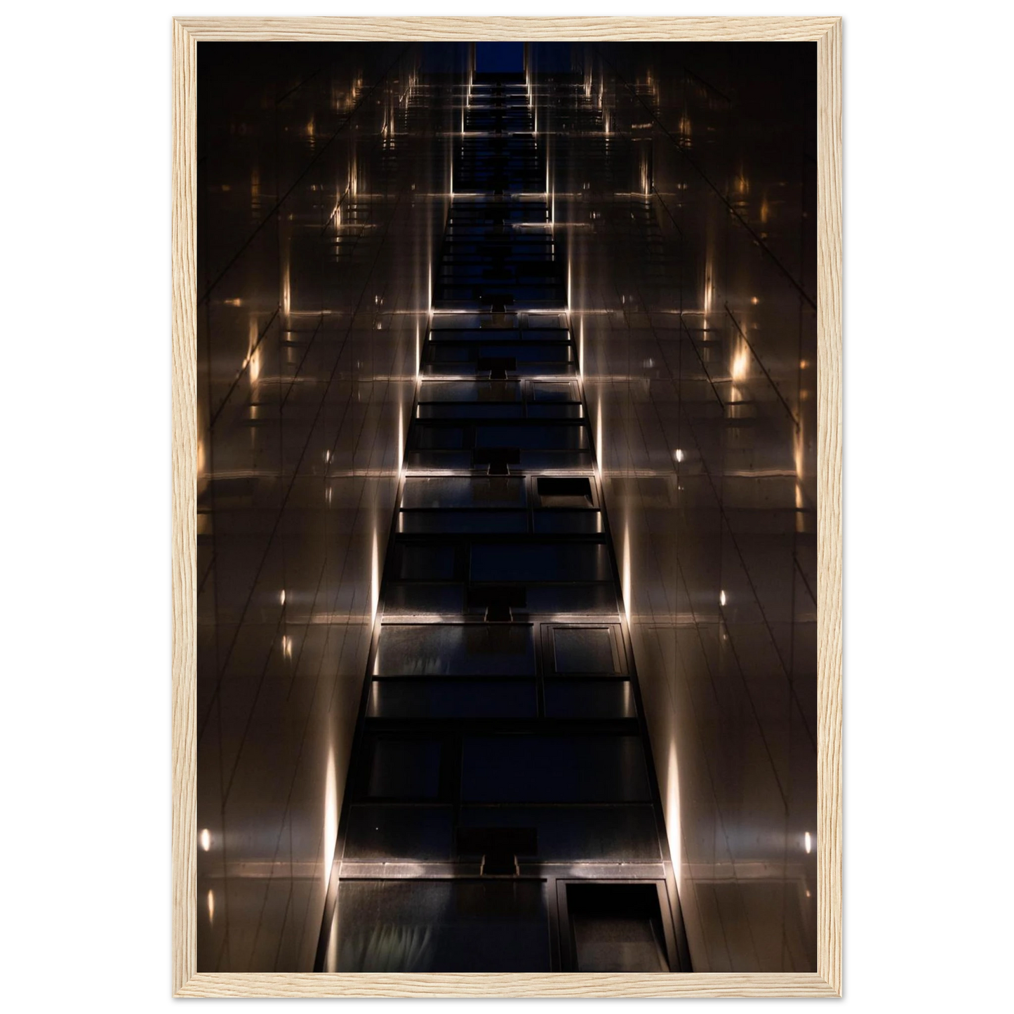 Low angle view looking up a narrow corridor-like passage between two skyscraper walls lined with rows of windows stretching toward the sky on wooden framed wall art