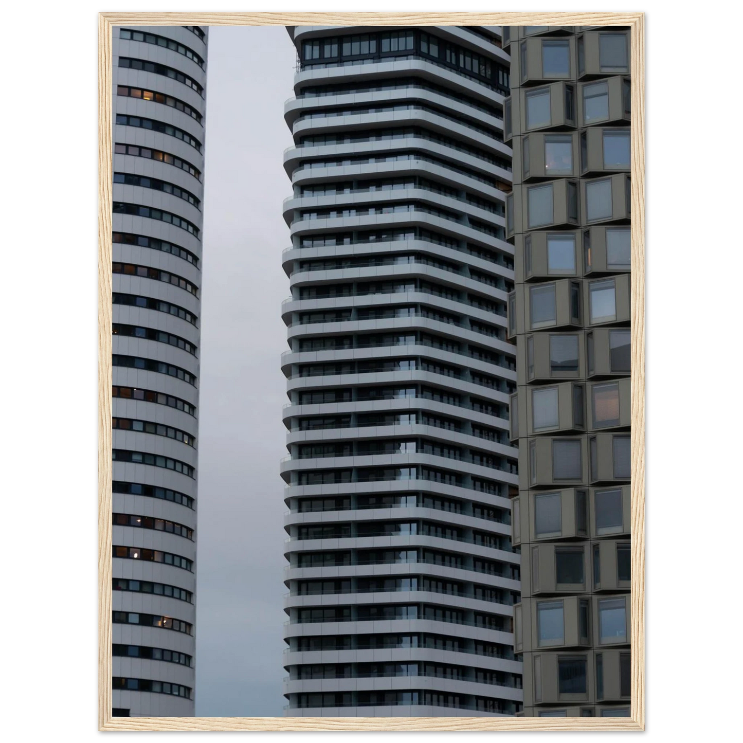 Modern high rise tower buildings with glass and steel facade reaching into the sky on wodden framed wall art