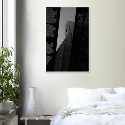 Black and white Low angle view looking up at a tall glass skyscraper framed between two metal structural elements on Wooden frame wall art on the wall in the Bedroom