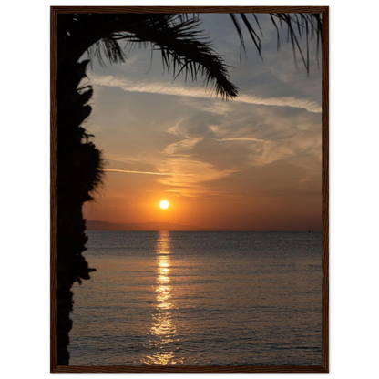 Wooden framed wall art Sunset over calm water with golden reflections, framed by tree branches in a peaceful natural landscape
