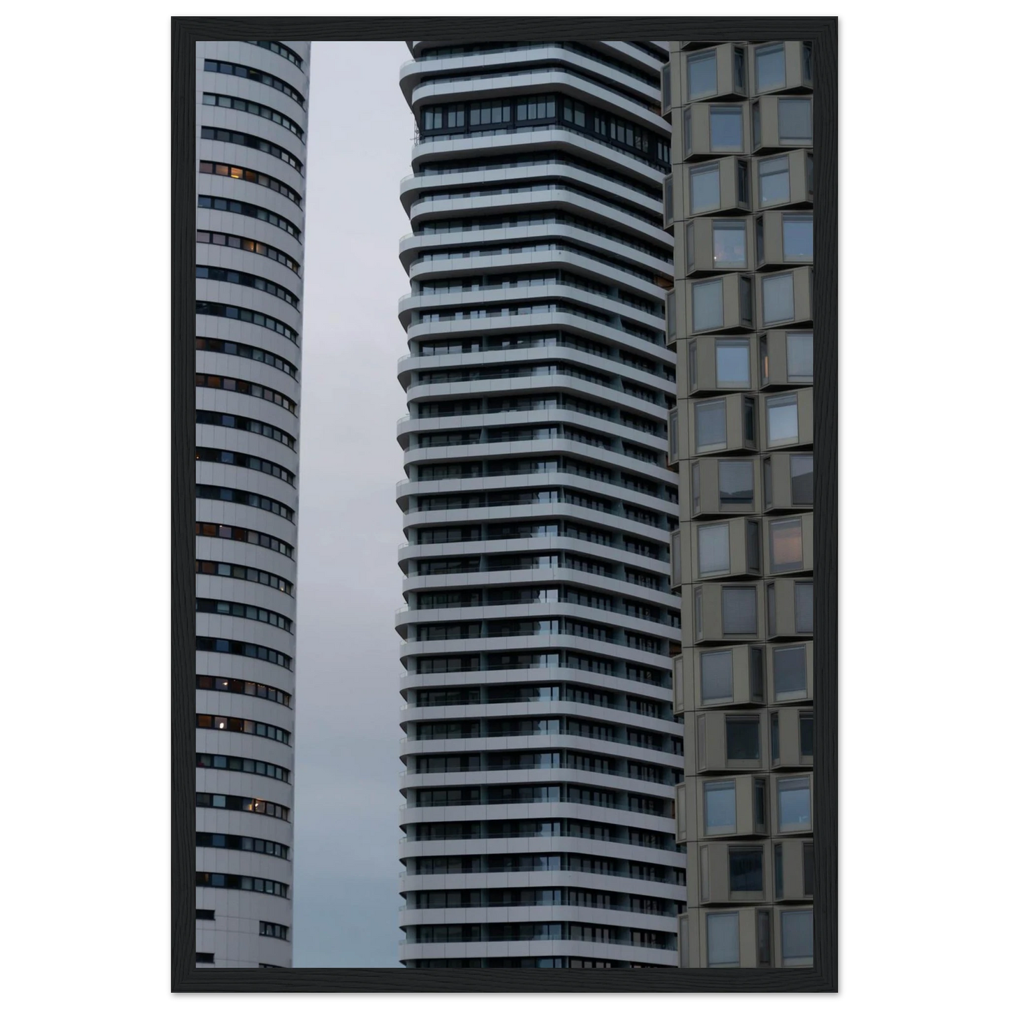 Modern high rise tower buildings with glass and steel facade reaching into the sky on wodden framed wall art