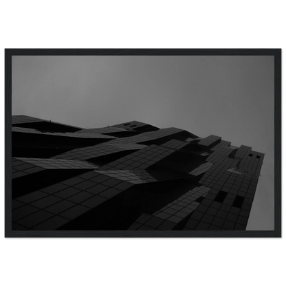 Black and white low angle view of a modern skyscraper with bold geometric lines and dark textured facade on wooden framed wall art