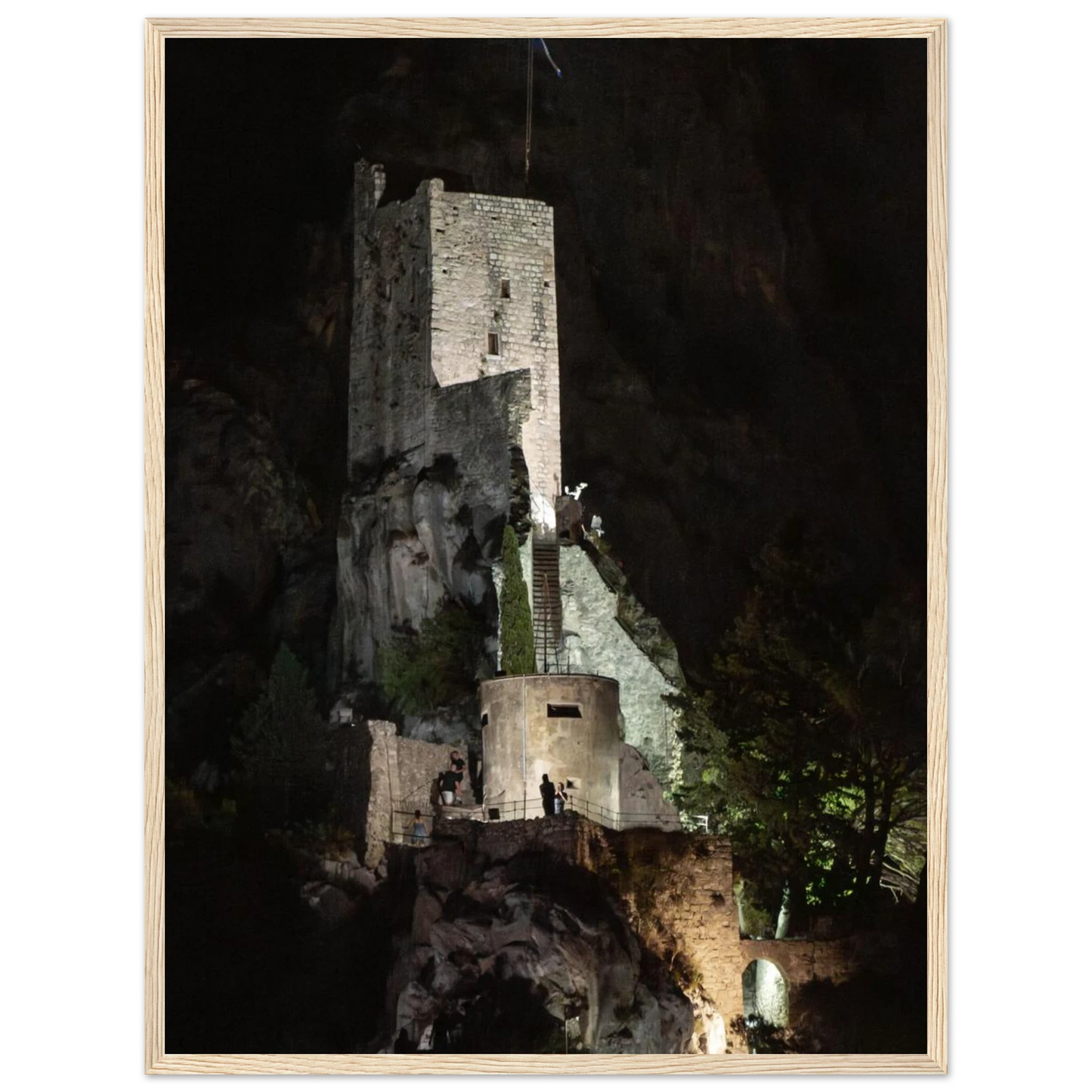 Wooden framed wall art of an ancient stone bastion decorated with green climbing plants against a dark background in Shadow Keep