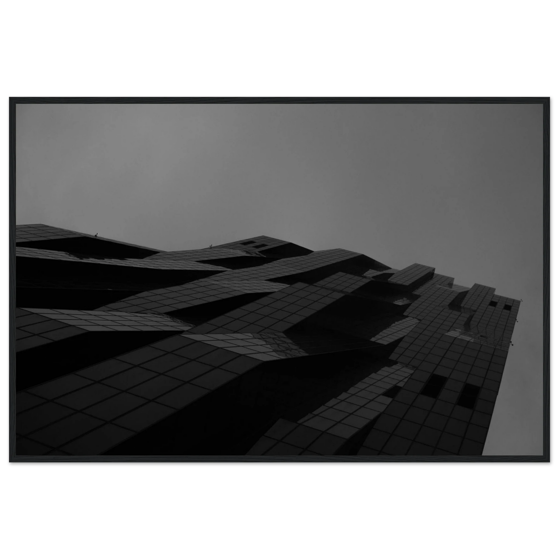 Black and white low angle view of a modern skyscraper with bold geometric lines and dark textured facade on wooden framed wall art