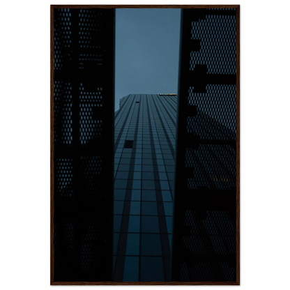Low angle view looking up at a tall glass skyscraper framed between two metal structural elements on wooden framed wall art