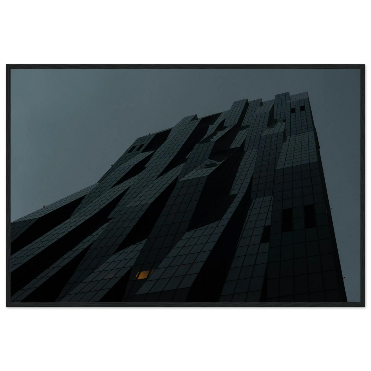 Bluish low angle view of a modern skyscraper with bold geometric lines and dark textured facade on Wooden framed wall art