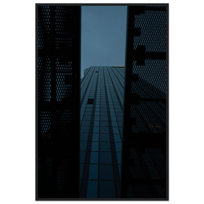 Low angle view looking up at a tall glass skyscraper framed between two metal structural elements on wooden framed wall art