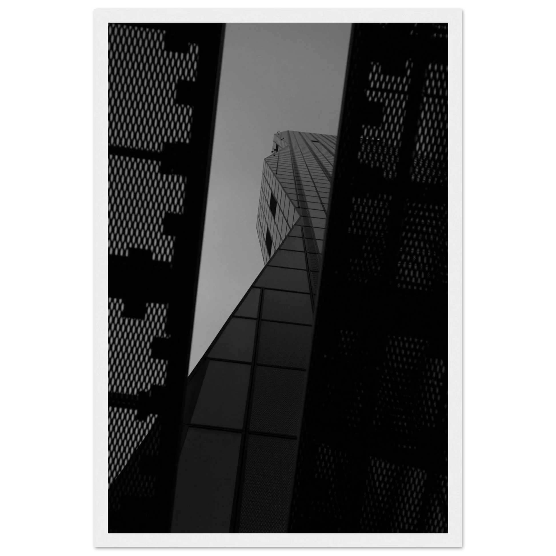 Black and white Low angle view looking up at a tall glass skyscraper framed between two metal structural elements on Wooden frame wall art