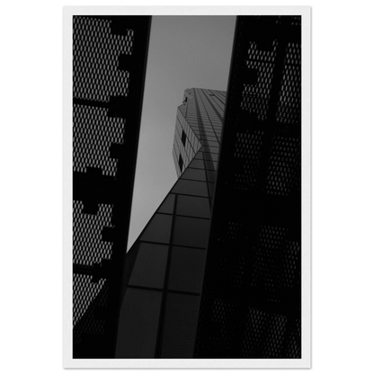 Black and white Low angle view looking up at a tall glass skyscraper framed between two metal structural elements on Wooden frame wall art