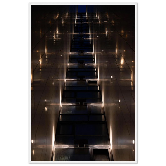 Low angle view looking up a narrow corridor-like passage between two skyscraper walls lined with rows of windows stretching toward the sky on wooden framed wall art