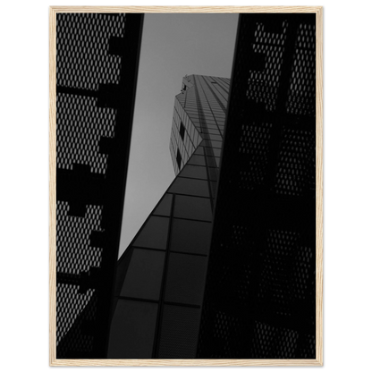 Black and white Low angle view looking up at a tall glass skyscraper framed between two metal structural elements on Wooden frame wall art