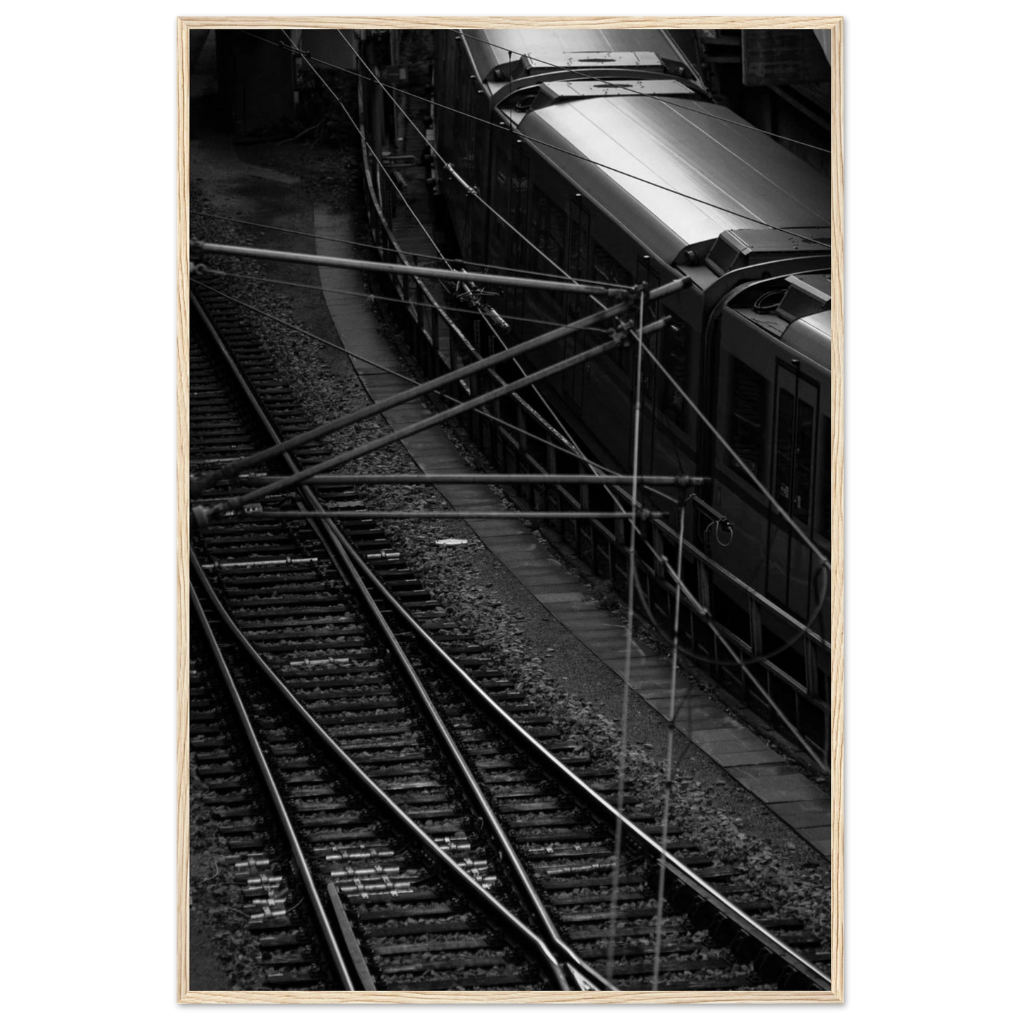 Black and white aerial view of metro train and railway tracks in an urban underground or elevated rail system on wooden framed wall art