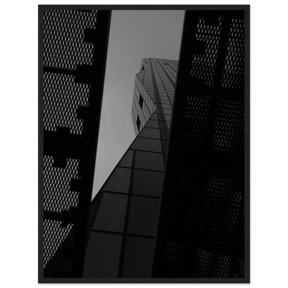 Black and white Low angle view looking up at a tall glass skyscraper framed between two metal structural elements on Wooden frame wall art