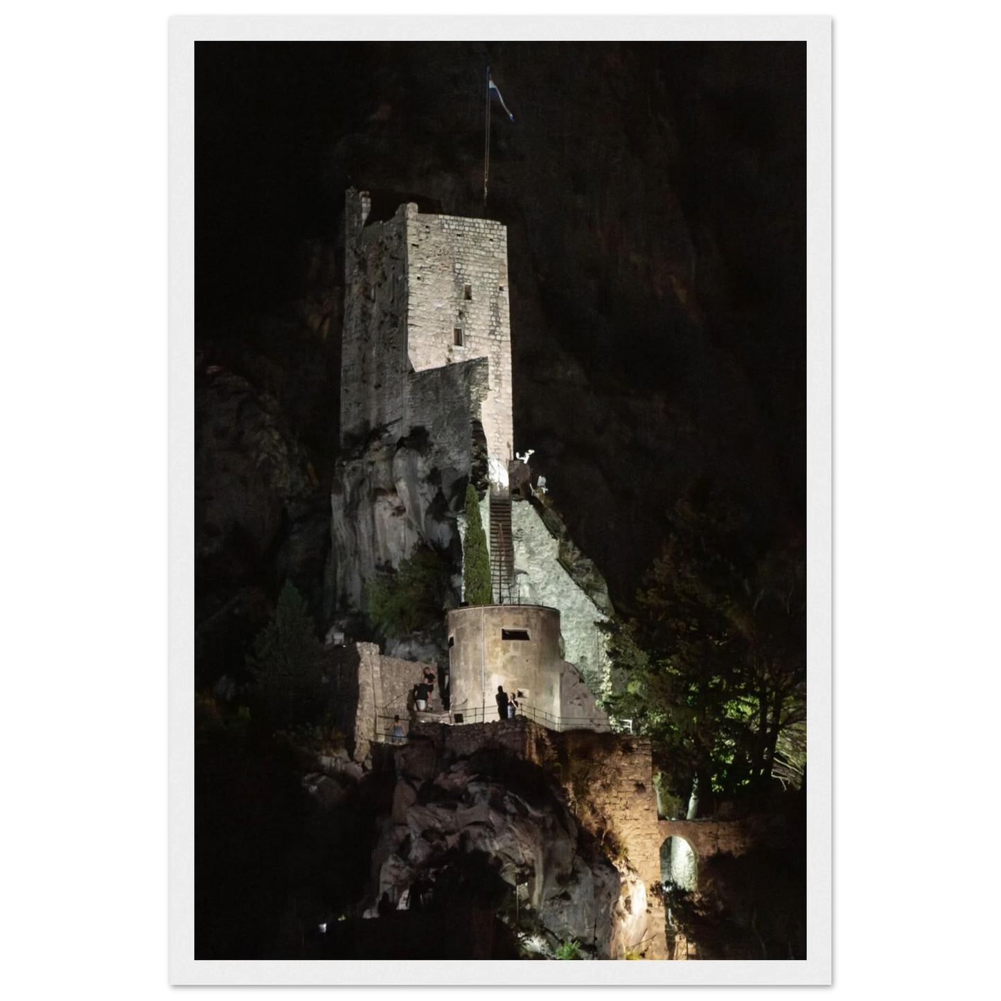 Wooden framed wall art of an ancient stone bastion decorated with green climbing plants against a dark background in Shadow Keep