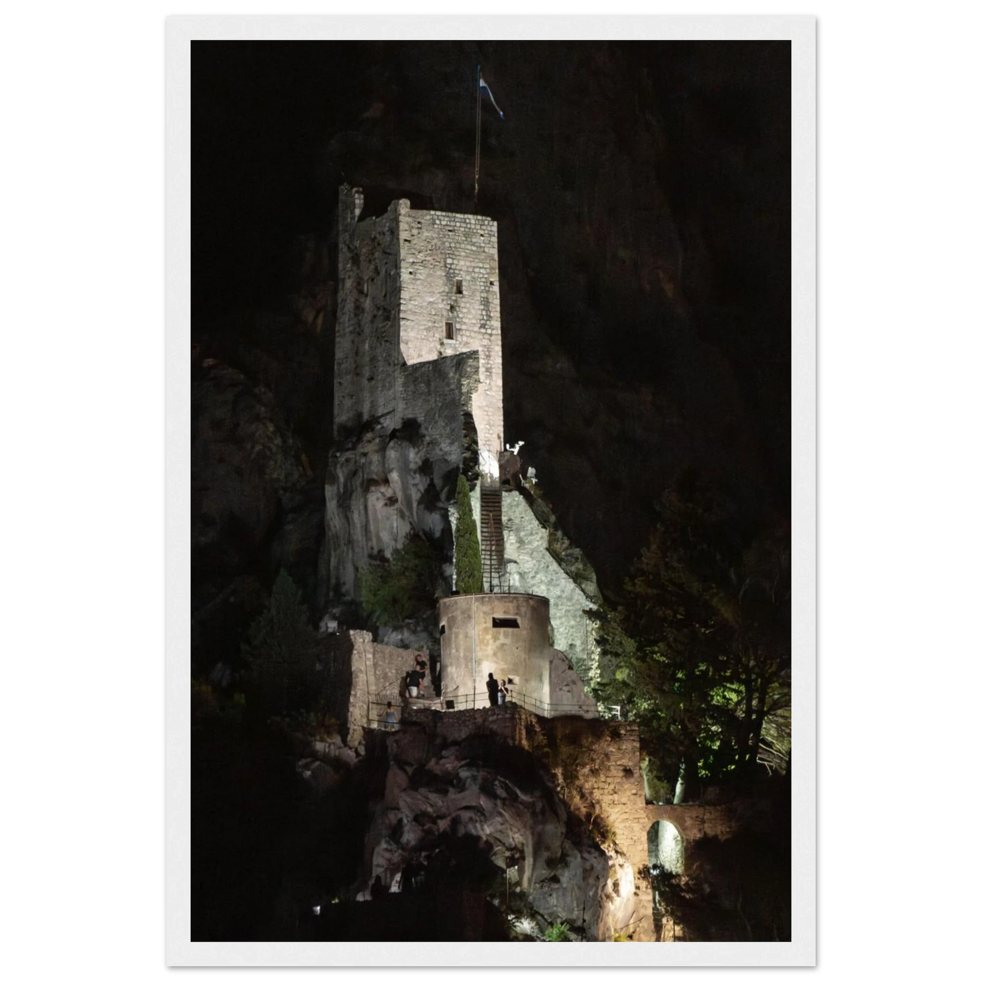 Wooden framed wall art of an ancient stone bastion decorated with green climbing plants against a dark background in Shadow Keep