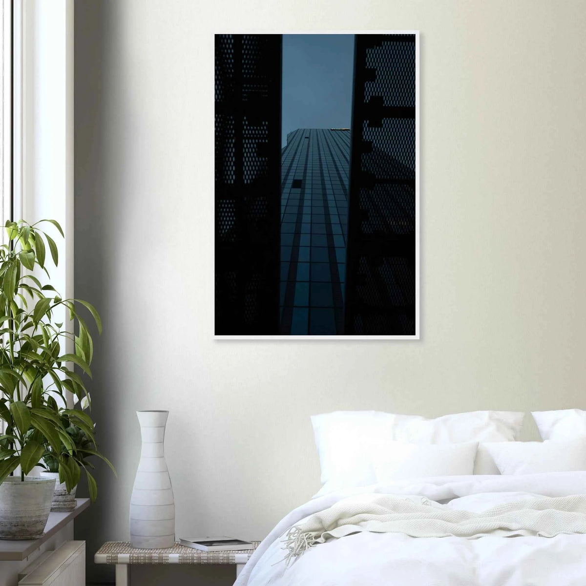 Low angle view looking up at a tall glass skyscraper framed between two metal structural elements on wooden framed wall art on the wall in the Bedroom
