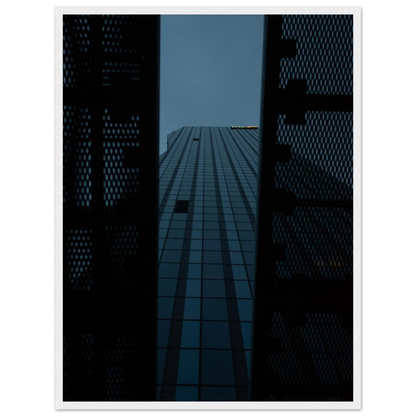 Low angle view looking up at a tall glass skyscraper framed between two metal structural elements on wooden framed wall art
