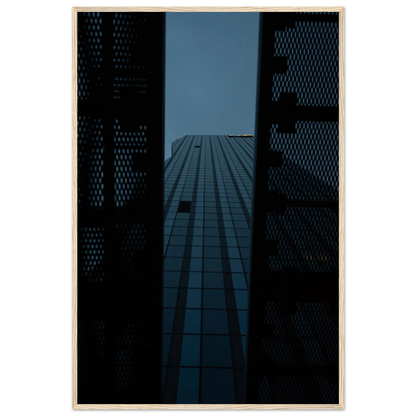 Low angle view looking up at a tall glass skyscraper framed between two metal structural elements on wooden framed wall art
