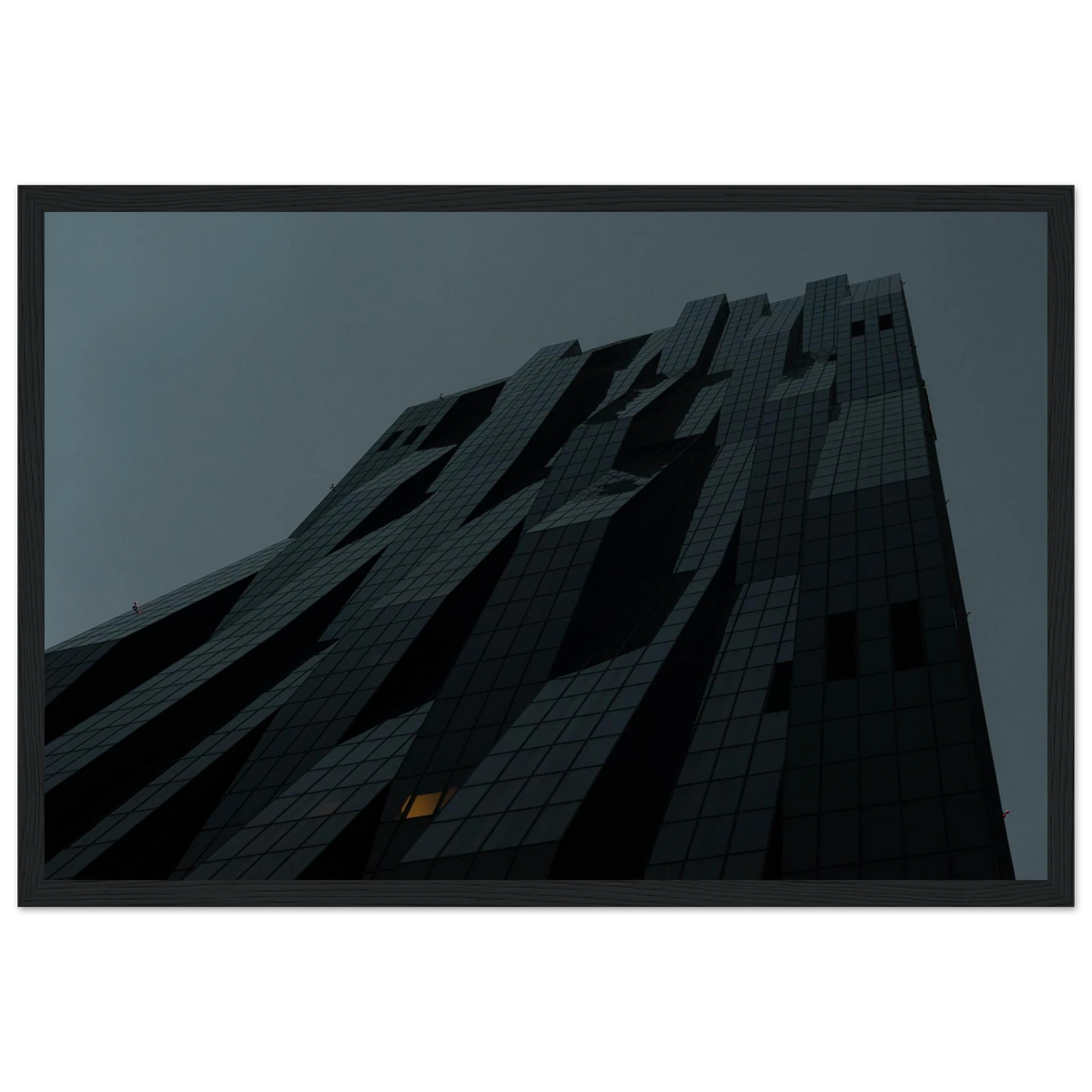 Bluish low angle view of a modern skyscraper with bold geometric lines and dark textured facade on Wooden framed wall art