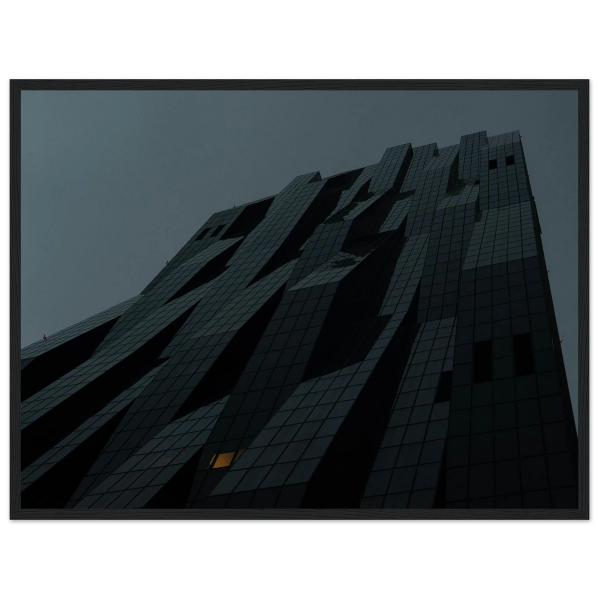 Bluish low angle view of a modern skyscraper with bold geometric lines and dark textured facade on Wooden framed wall art