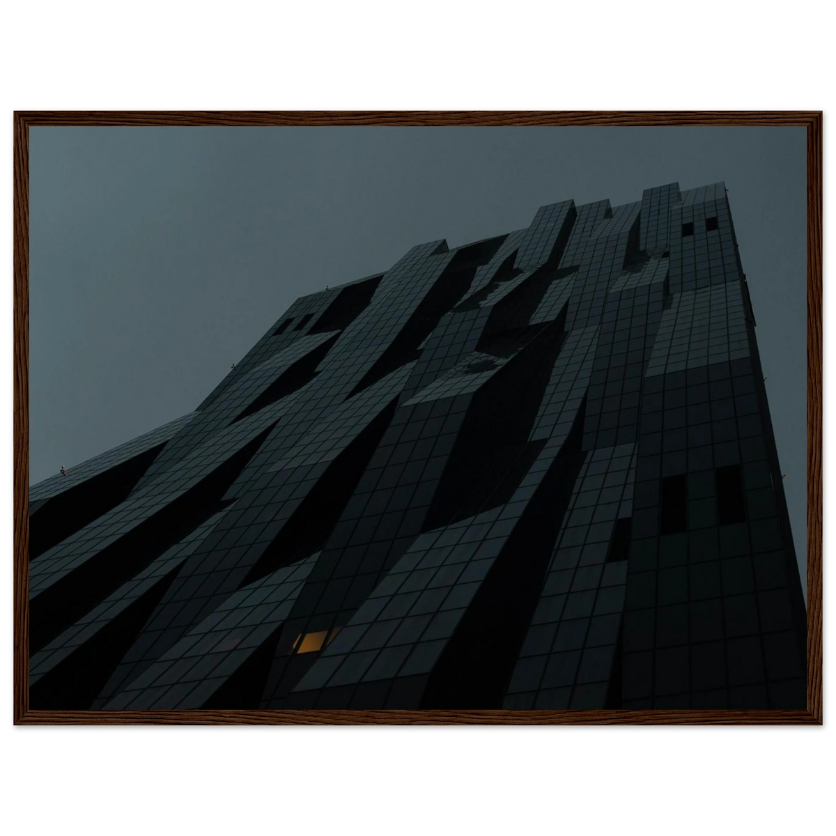 Bluish low angle view of a modern skyscraper with bold geometric lines and dark textured facade on Wooden framed wall art