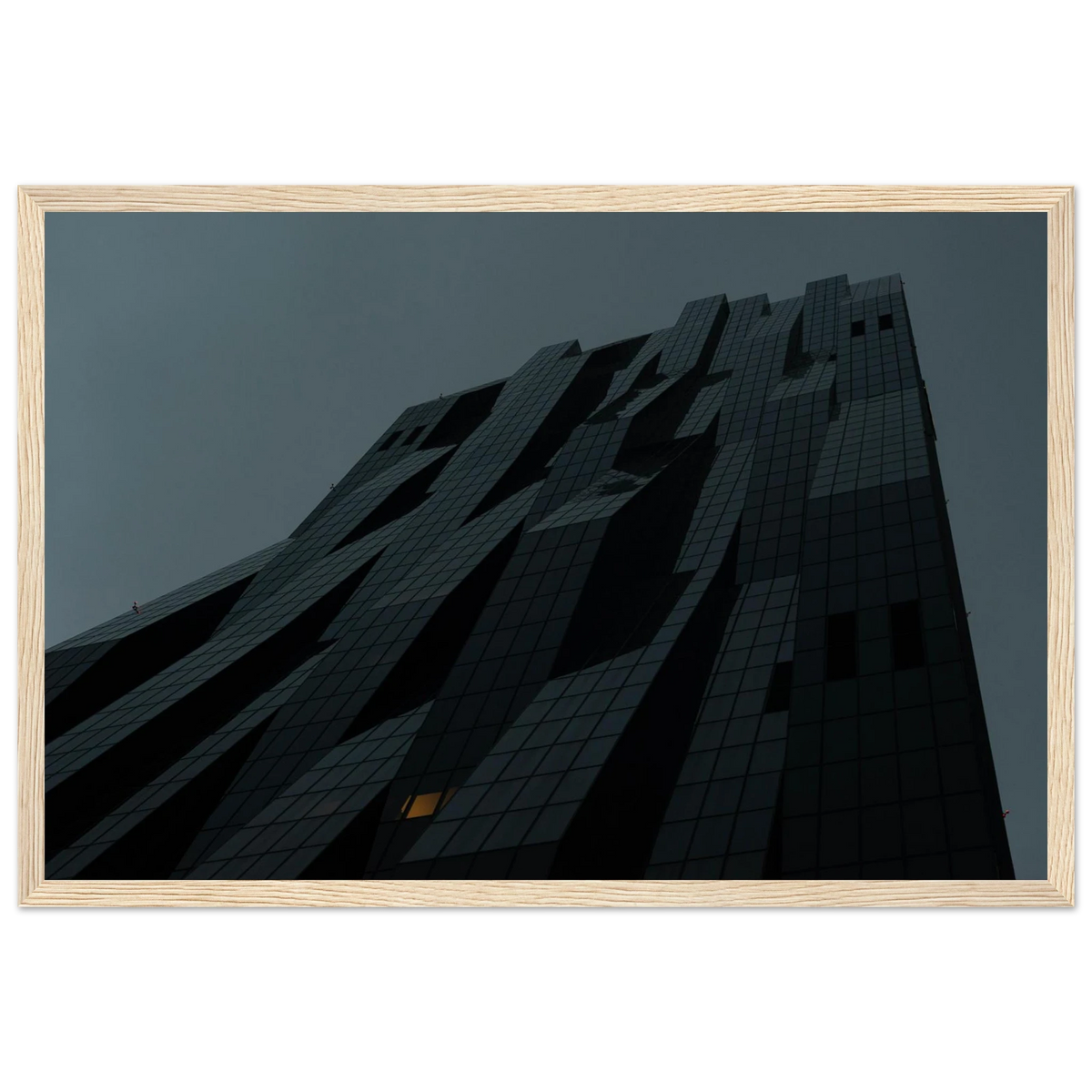 Bluish low angle view of a modern skyscraper with bold geometric lines and dark textured facade on Wooden framed wall art