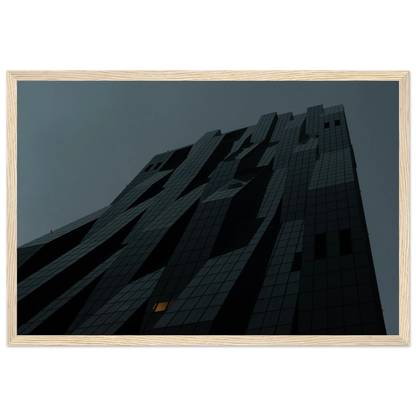 Bluish low angle view of a modern skyscraper with bold geometric lines and dark textured facade on Wooden framed wall art