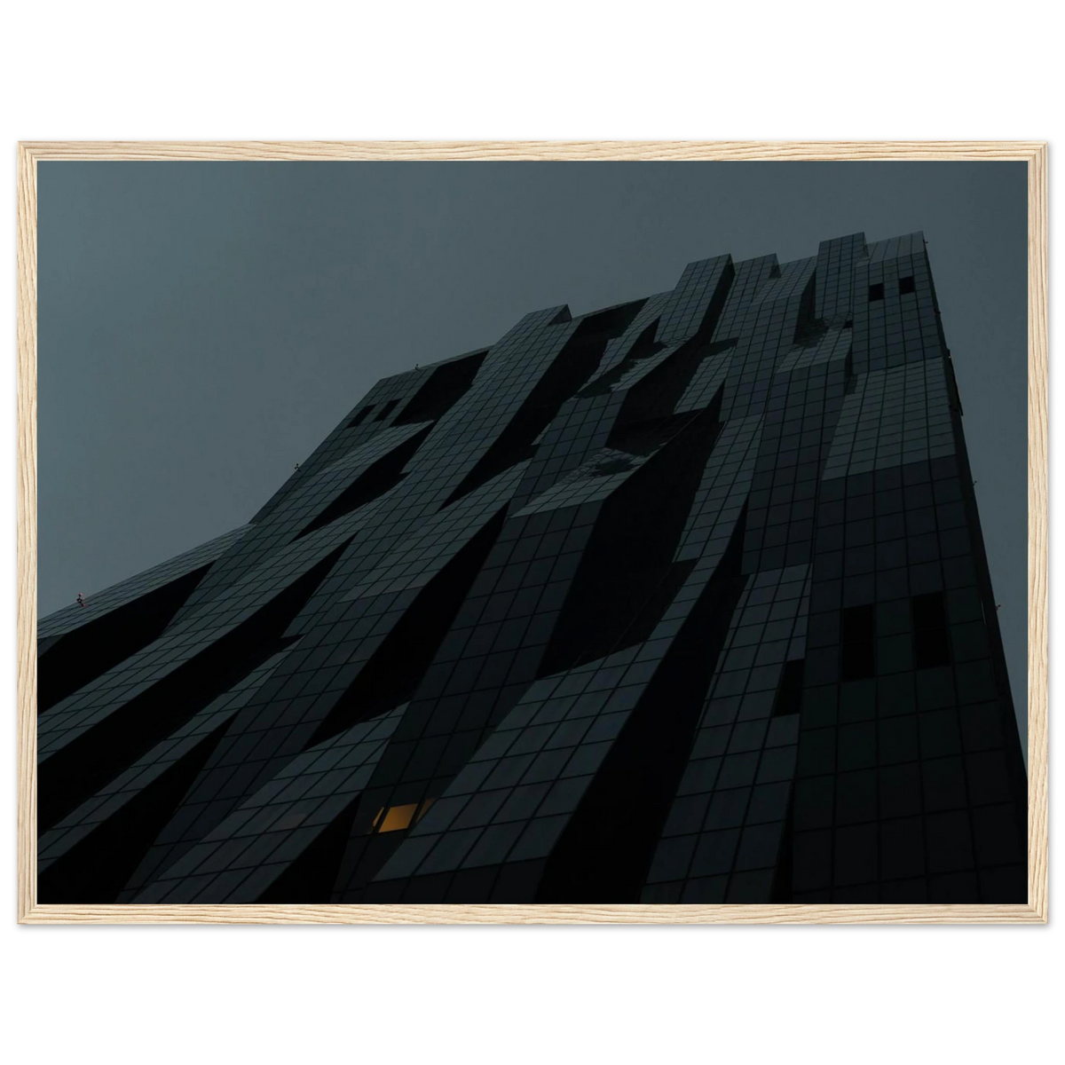 Bluish low angle view of a modern skyscraper with bold geometric lines and dark textured facade on Wooden framed wall art