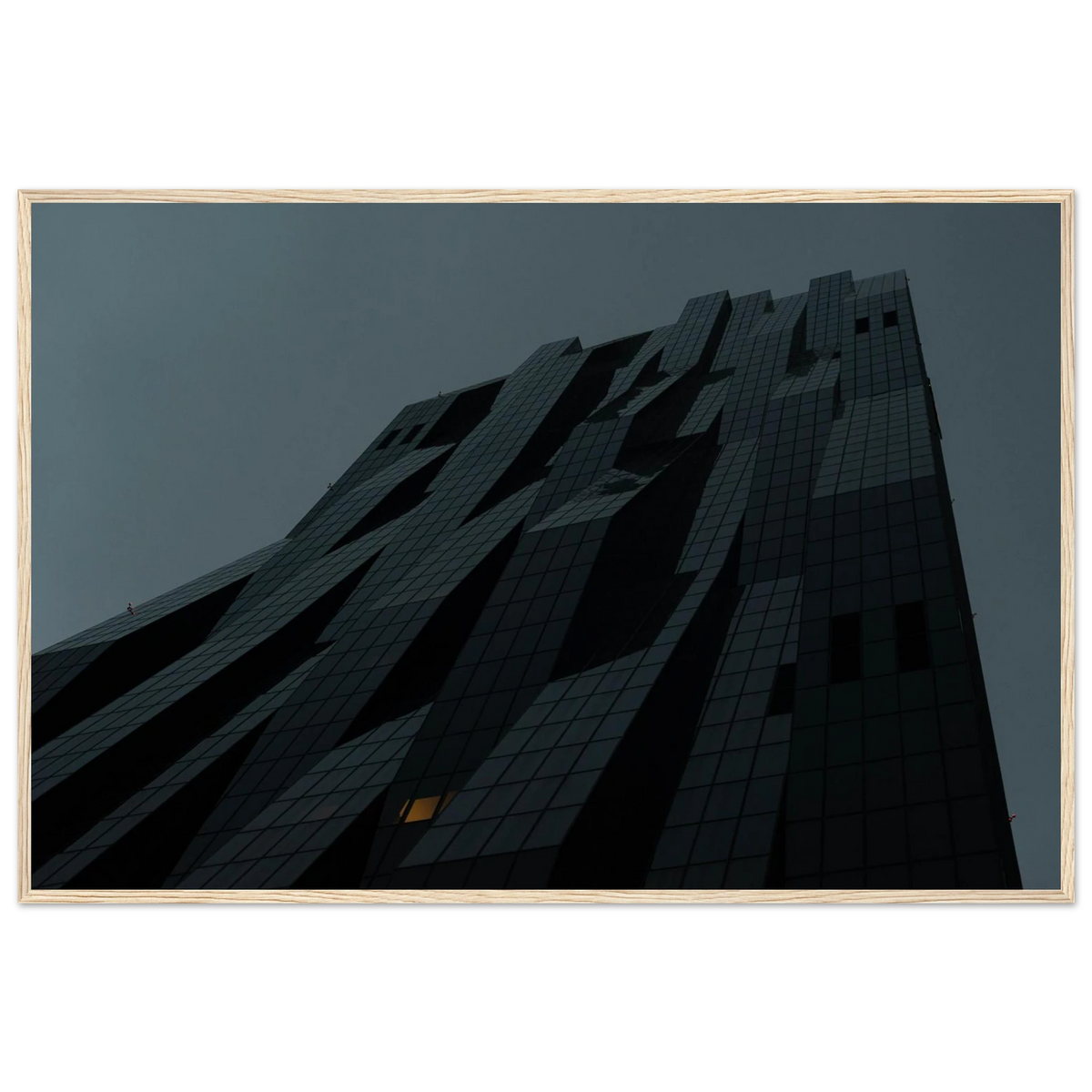 Bluish low angle view of a modern skyscraper with bold geometric lines and dark textured facade on Wooden framed wall art