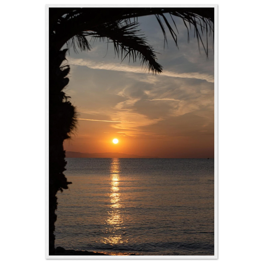 Wooden framed wall art Sunset over calm water with golden reflections, framed by tree branches in a peaceful natural landscape