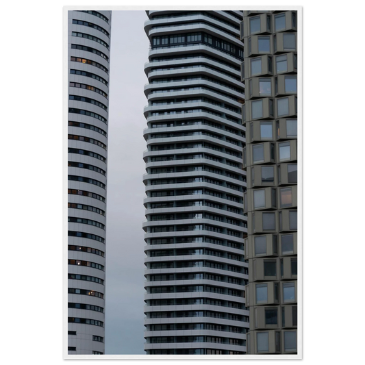 Modern high rise tower buildings with glass and steel facade reaching into the sky on wodden framed wall art