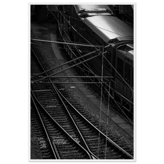 Black and white aerial view of metro train and railway tracks in an urban underground or elevated rail system on wooden framed wall art